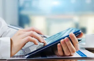person using a touch screen tablet